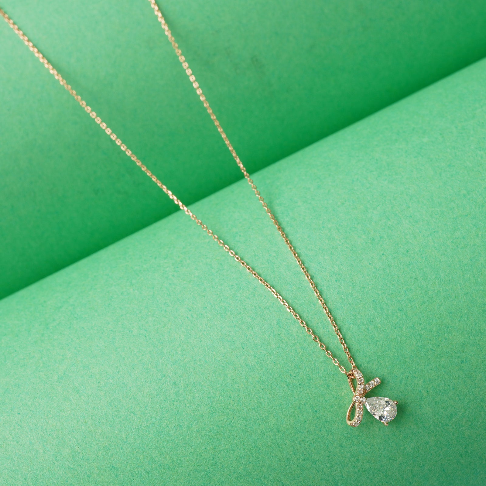 Rose gold plated bow tie pendant necklace
