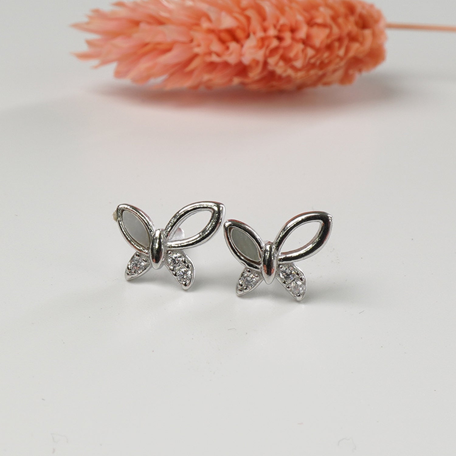 close up of butterfly design on 925 silver stud earrings