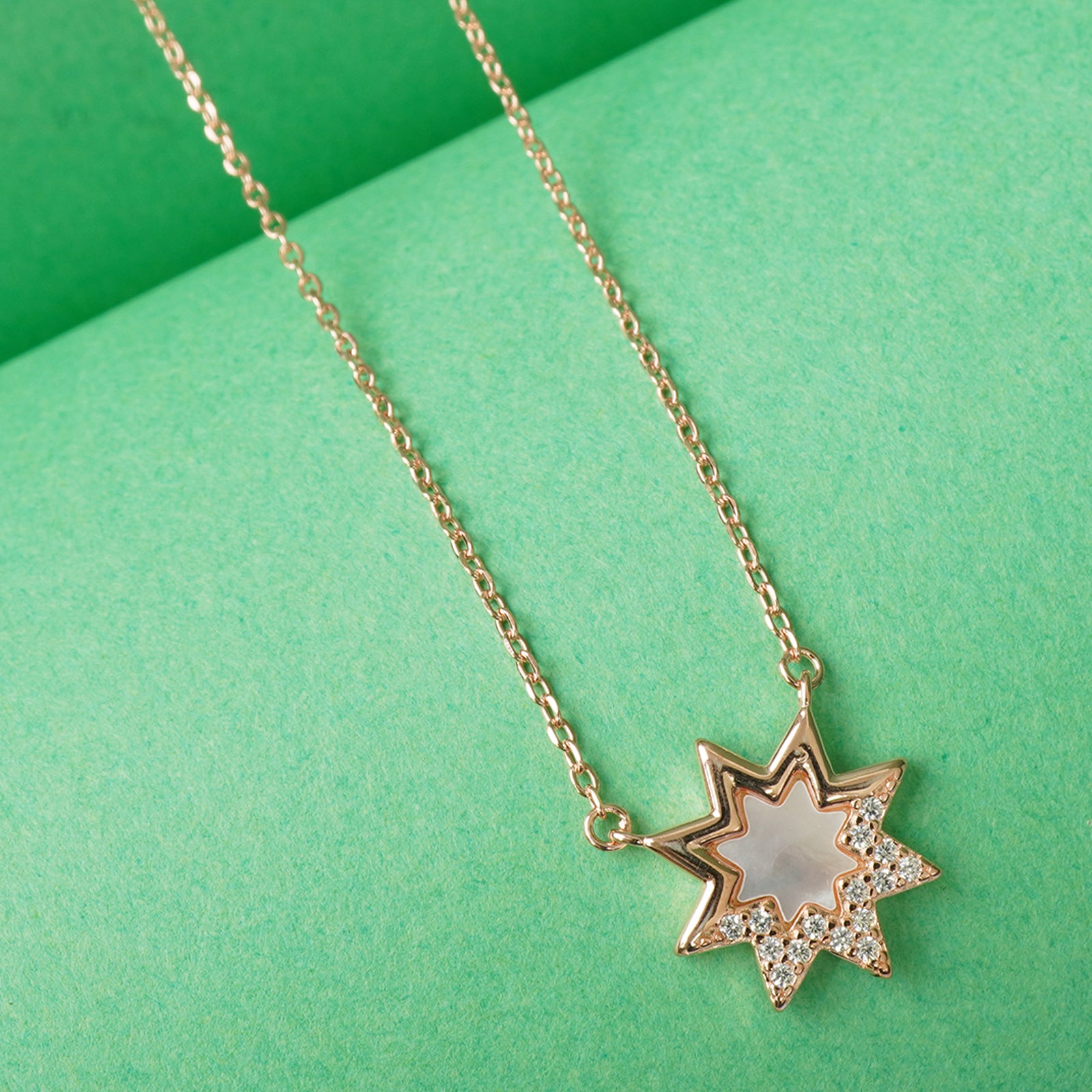 close up of dainty star pendant on rose gold plated 925 silver necklace