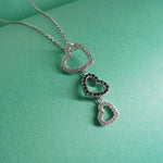 Indian Sterling Silver heart-shaped necklace on a teal background