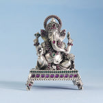 silver ganeshji idol on a blue background