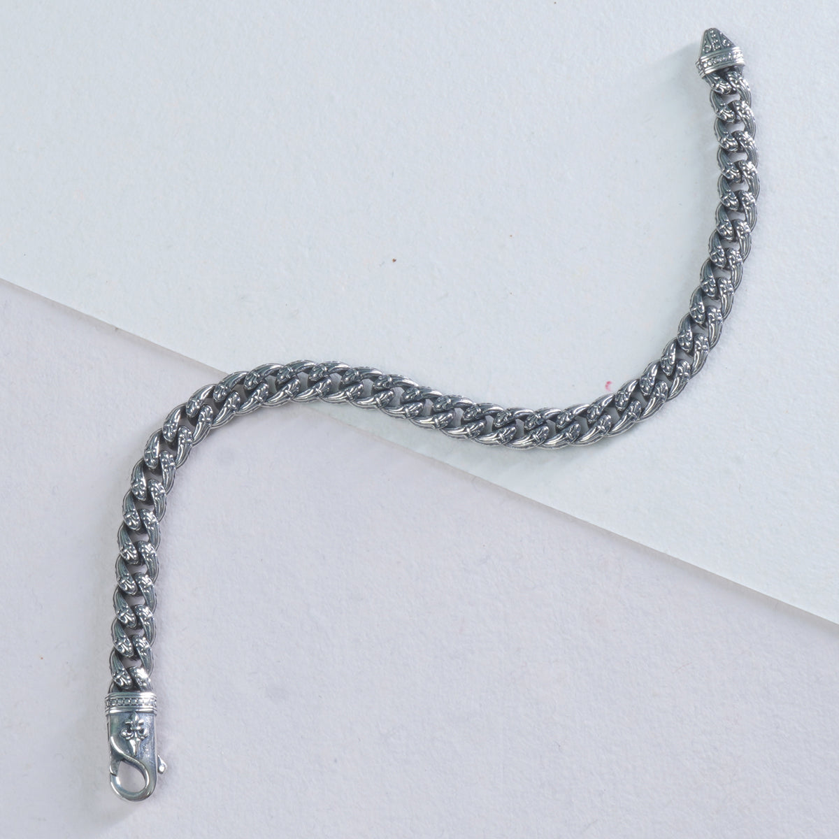 mini silver cuban bracelet on a white background