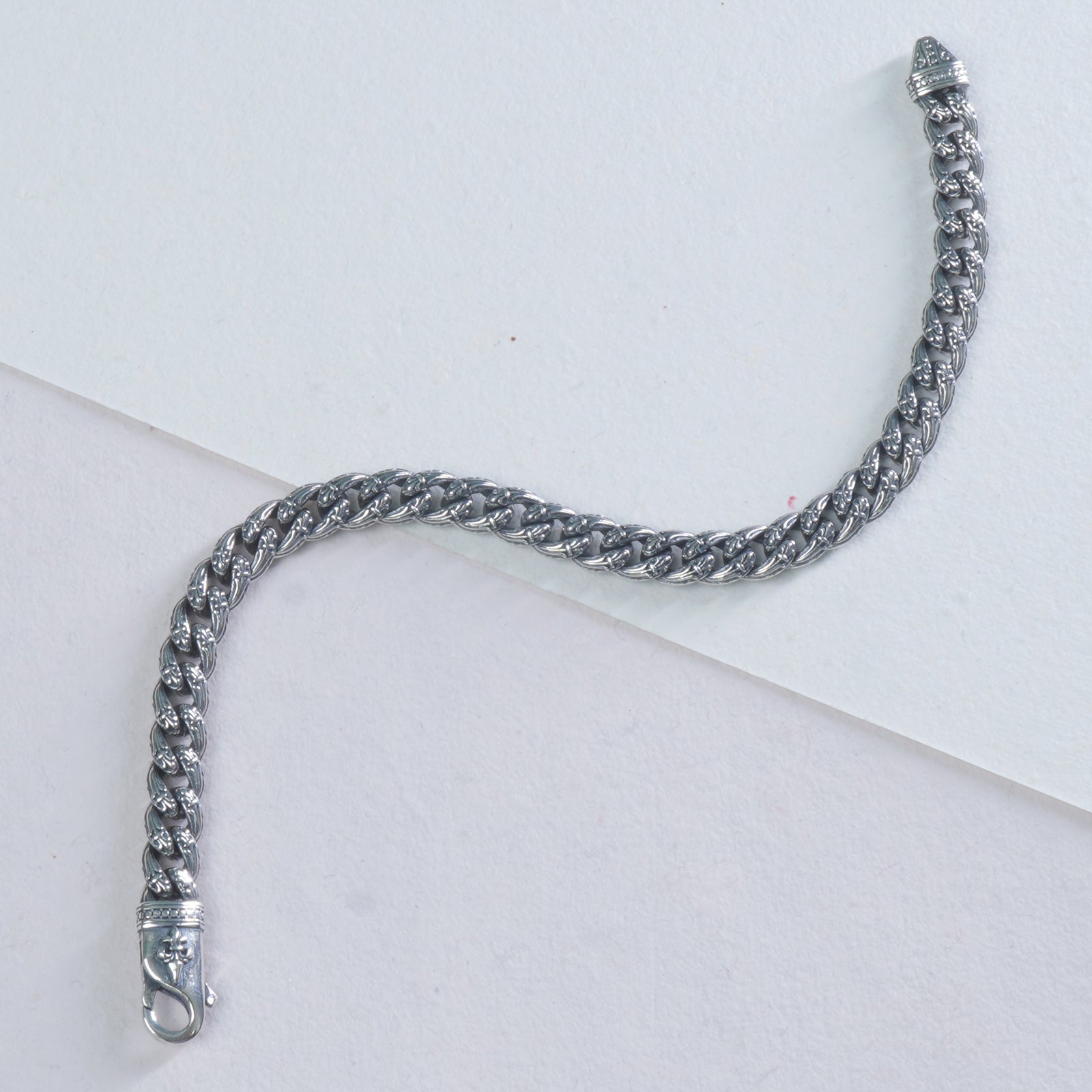 mini silver cuban bracelet on a white background