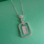 sterling Silver necklace with a rectangular pendant on a green background
