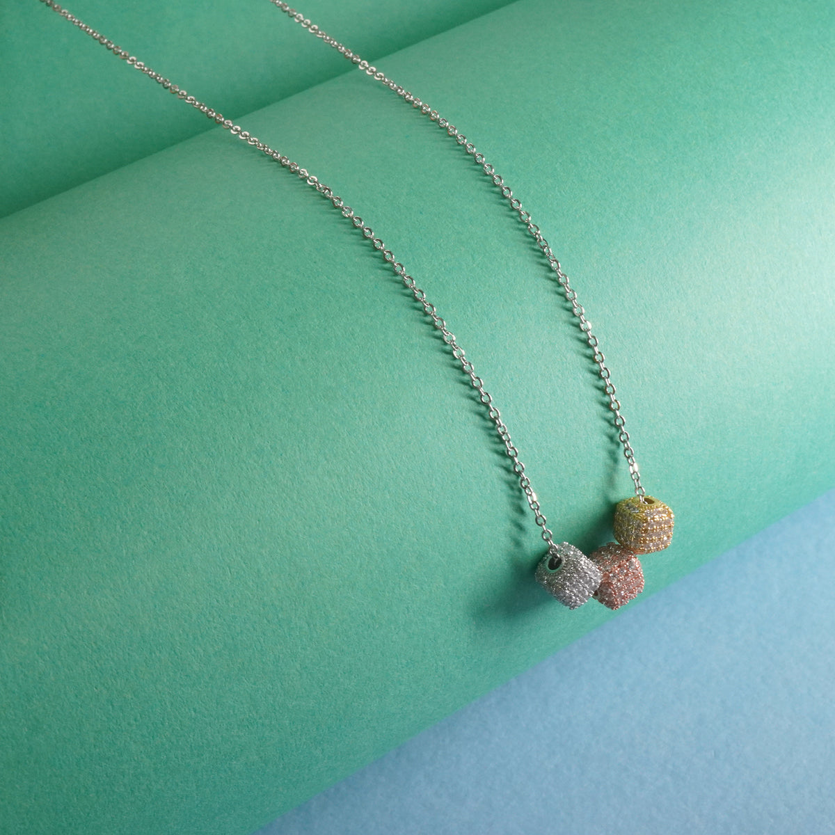Sterling silver chain with 3 dice shaped silver pendants studded with stone