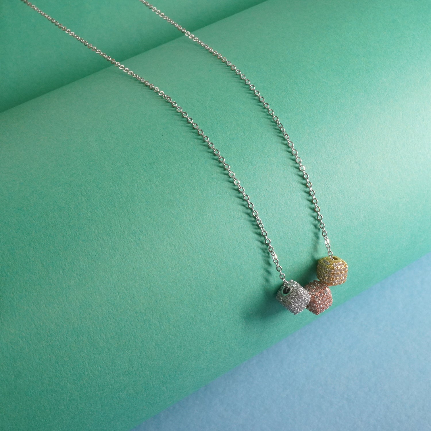 Sterling silver chain with 3 dice shaped silver pendants studded with stone
